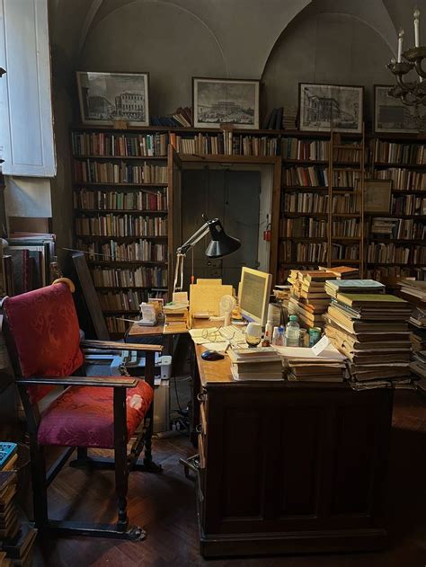 Desk with a lamp lighting up the surrounding piles of books lining the desk. Room Inspo, Room ...