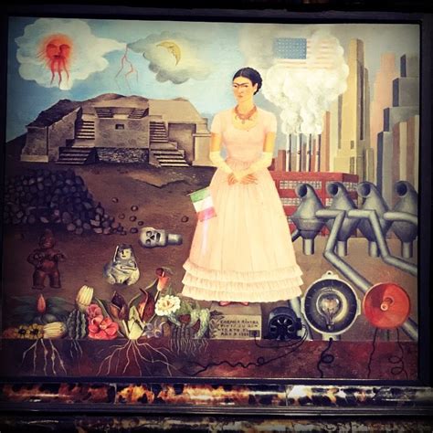 Kahlo stands upon a pedestal as “Carmen Riviera” wearing a pink dress, coral necklace and lace ...