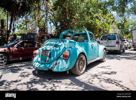 Man driving retro vintage classic style car on road amidst traffic Stock Photo - Alamy