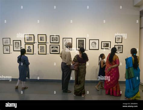 People watching the paintings on display in an exhibition in Chitrakala Parishath in Bangalore ...