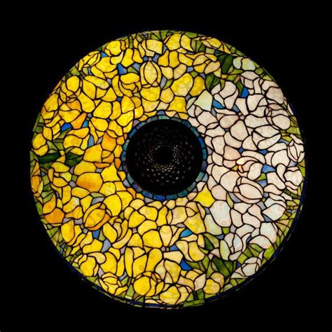 a circular stained glass window with yellow flowers