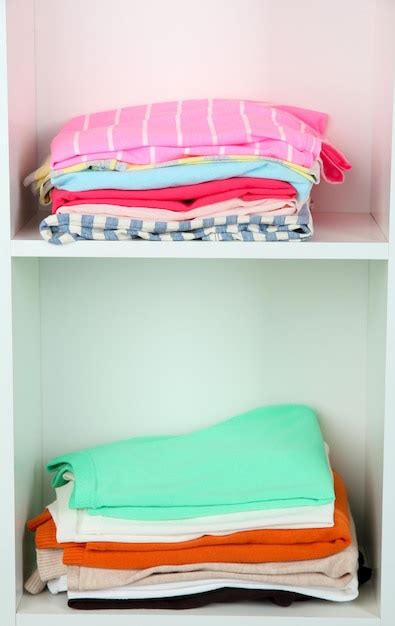 Premium Photo | Clothes neatly folded on shelves