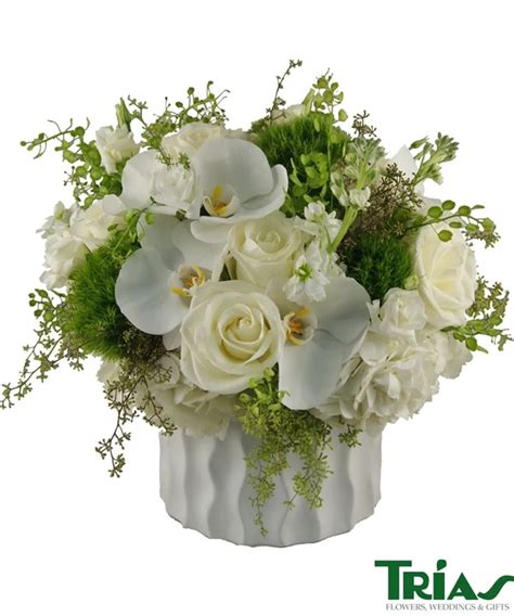 An elegant and angelic arrangement of white hydrangeas, green dianthus balls, white phalaenopsis ...