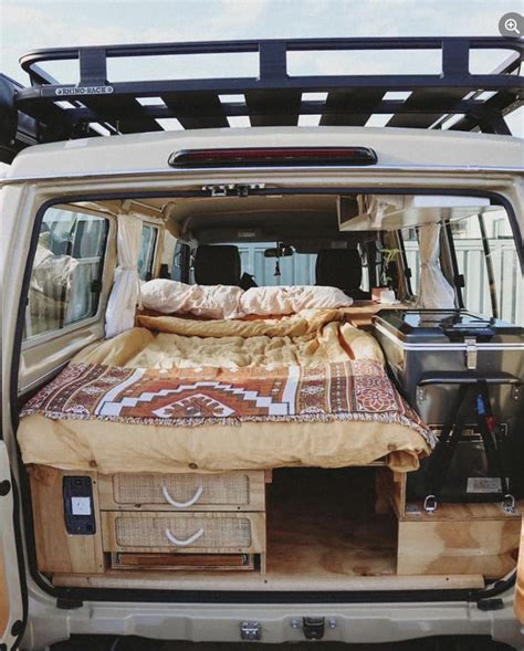 the back end of a van with a bed in it