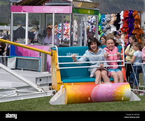 Two young girls on a fun fair ride Stock Photo - Alamy