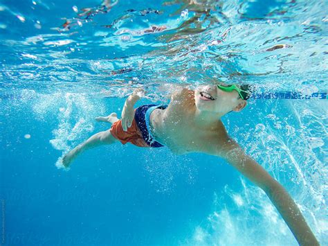 "Young Asian Boy Swimming Underwater" by Stocksy Contributor "Curtis ...