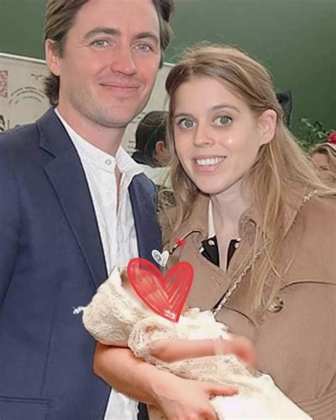 a man in a suit and tie holding a stuffed animal with a heart on it