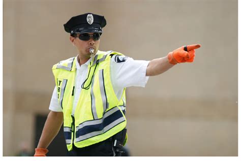 6 Police officer in Minneapolis signals that traffic can start moving ...