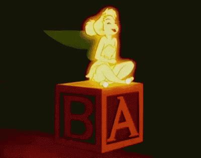 a lit up figure sitting on top of a block with the letter b in it