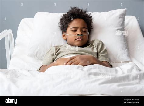 Hard sick boy with tubes in his nose sleeping in bed at hospital Stock Photo - Alamy