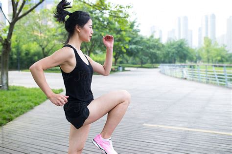 «Young Asian Woman Doing Exercise In The Park» del colaborador de ...