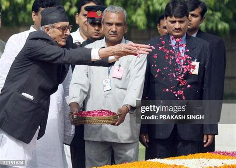 Nepal's Prime Minister Girija Prasad Koirala sprinkles rose petals at ...