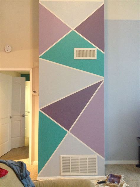 a living room with a wall painted in different colors