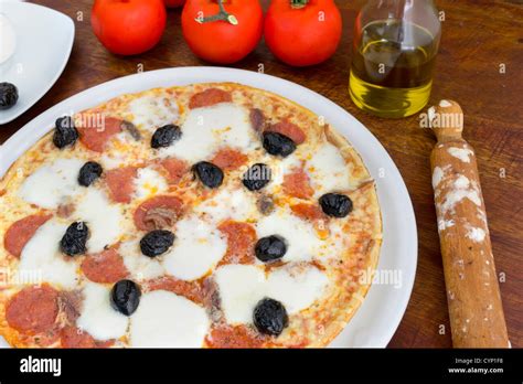 pizza with olives, pepperoni and anchovies Stock Photo - Alamy