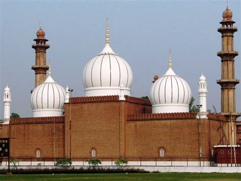 a large building with three white domes on it's sides and two red brick ...