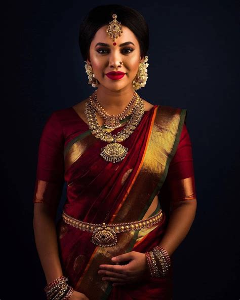 South Indian bride. Gold Indian bridal jewelry.Temple jewelry. Jhumkis.Red silk kanchipuram sa ...