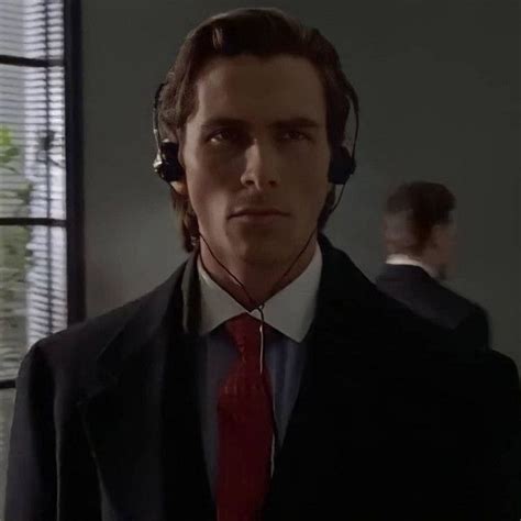 a man in a suit and tie wearing headphones