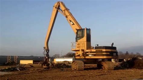 Caterpillar scrap yard crane in action. Steel Dynamics, Ticker STLD ...