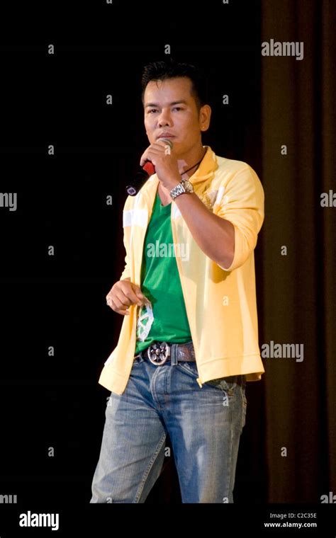 A male pop singer is singing for an audience at The Lao National ...