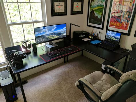 there is a computer desk with two monitors and a keyboard in front of the monitor