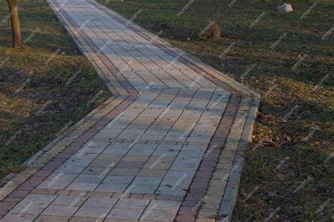 Premium Photo | A brick walkway with a red border and a white stripe.