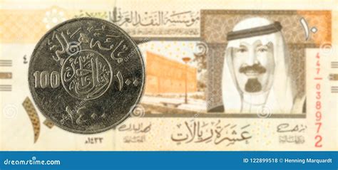 100 Saudi Riyal Coin Against 10 Saudi Riyal Bank Note Stock Photo ...