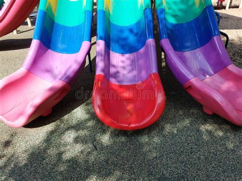 Multicolored Plastic Slides on Playground Stock Photo - Image of ...