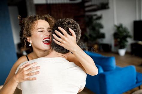 Overjoyed Happy Young Wife Hugging Her Husband, Standing at Home ...