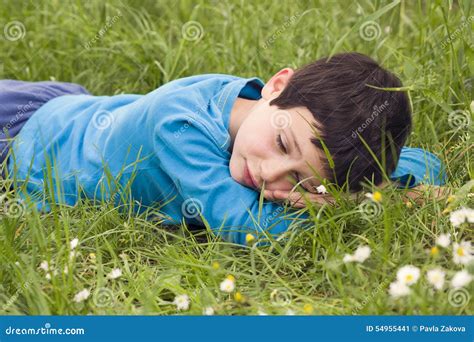 Child lying in grass stock image. Image of beautiful - 54955441