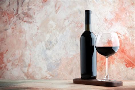 Free Photo | Front view glass of wine with bottle and chocolate on light background alcohol bar ...