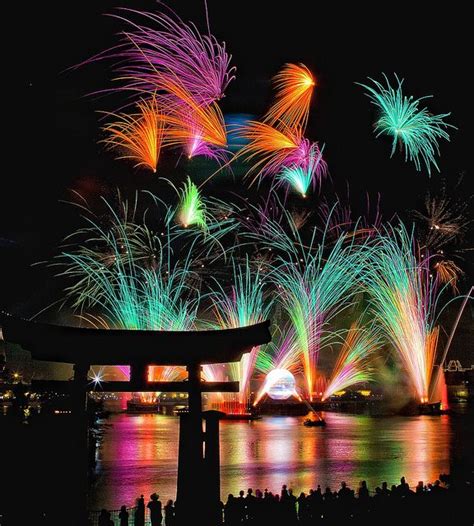 fireworks are lit up in the night sky over water