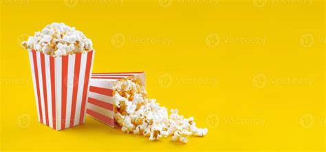 Two red white striped carton buckets with tasty cheese popcorn ...