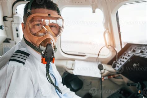 In oxygen mask. Pilot on the work in the passenger airplane. Preparing for takeoff 15409680 ...