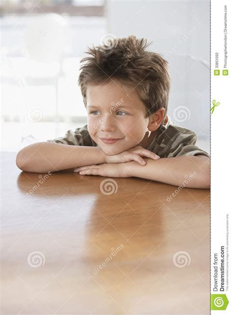 Boy Leaning on Wooden Dining Table Stock Photo - Image of indoors ...