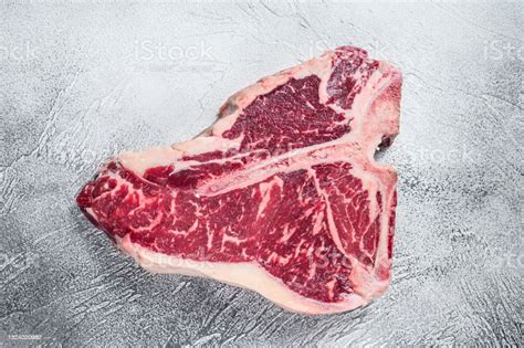 Raw Tbone Or Porterhouse Steak On Kitchen Table White Background Top ...