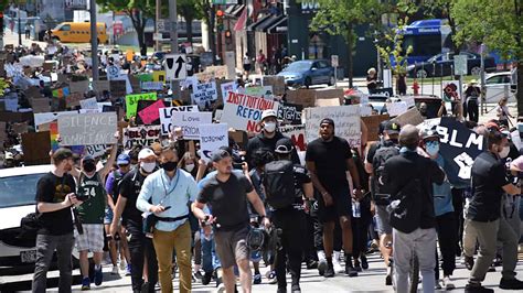 Bucks players, execs join thousands of protesters in downtown Milwaukee