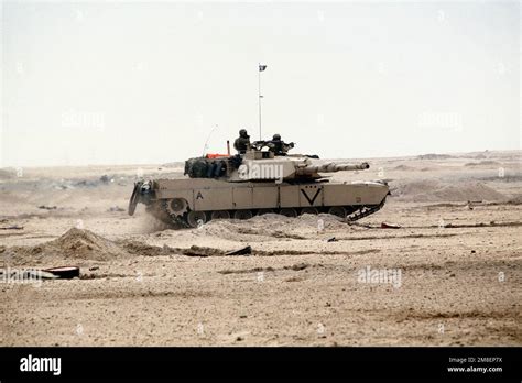 A Marine Corps M-1A1 Abrams main battle tank moves across the desert during the ground phase of ...