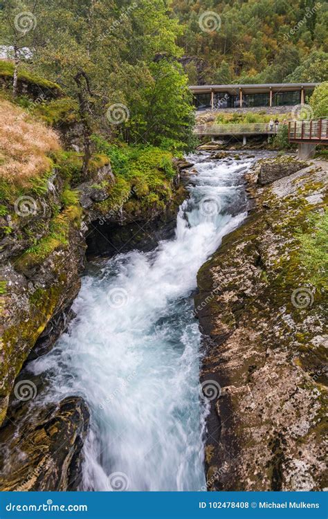 Waterfall in Geiranger with Norwegian Fjord Centre in Norway Editorial ...