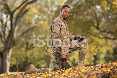 Kneeling Soldier Praying Over An American Flag Stock Photo | Royalty ...