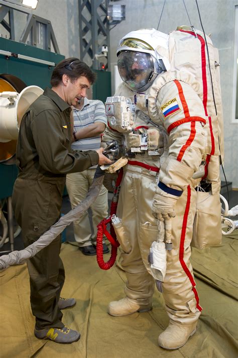 Putting On Orlan Space Suit