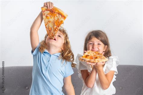 Funny kids eating pizza. Cute children little girl and boy eating tasty ...