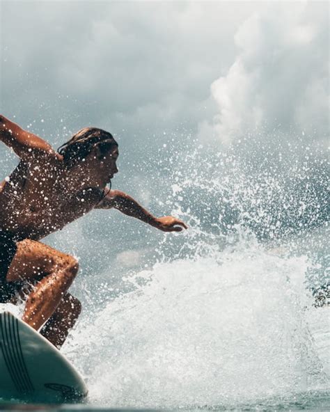 Man Riding White Surfboard · Free Stock Photo