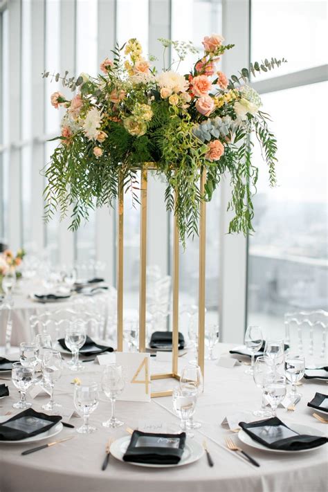 Round Tables with Elegant Tall Centerpieces - https://www.theknot.com ...