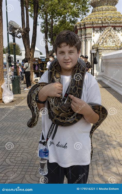 A Boy Holding A Snake Editorial Photo | CartoonDealer.com #179516221