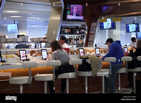 Airport passengers dine at airport restaurant bar in airport terminal ...