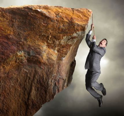 Businessman Hanging From Rope Off Of A Cliff Stock Photo - Download ...