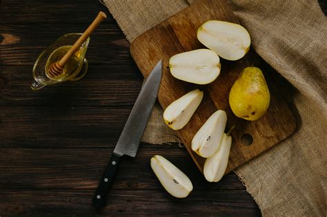 Sliced Apple Beside Knife on Brown Wooden Table · Free Stock Photo