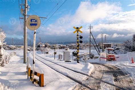 Railway track for local train with white snow fall in winter season ...