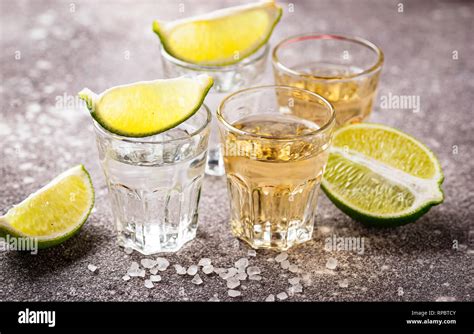 Shots of silver and gold tequila Stock Photo - Alamy