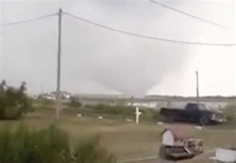 Waterspout-turned-tornado seen on video tearing roof off home